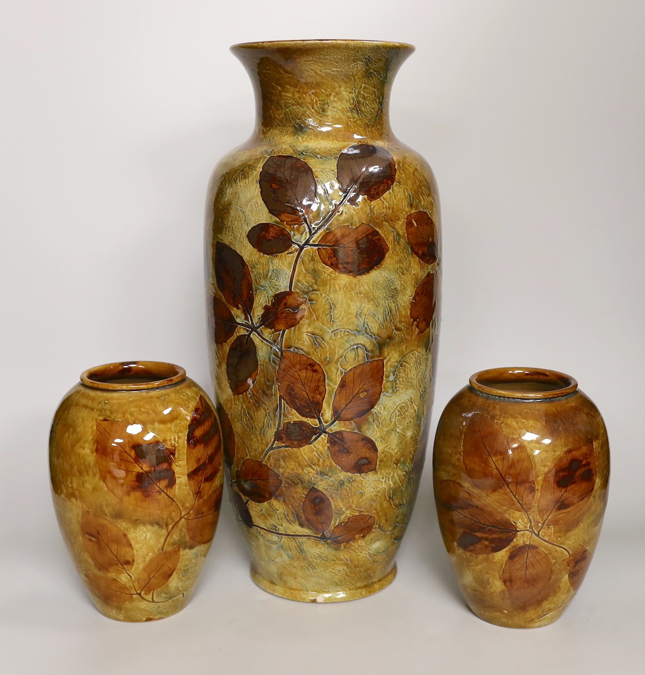 Royal Doulton Natural Foliage Ware - a pair of vases and a larger vase, larger vase 40cms high